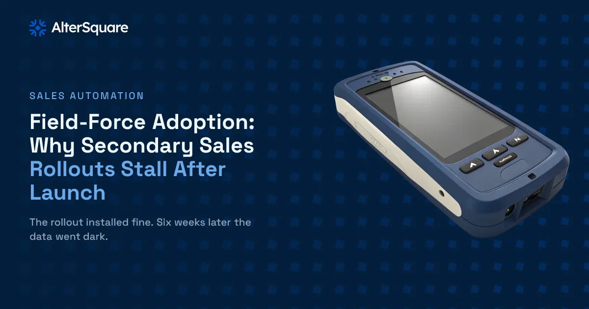 A powered-off rugged handheld sales device left face-down on a warehouse surface, screen dark and unused